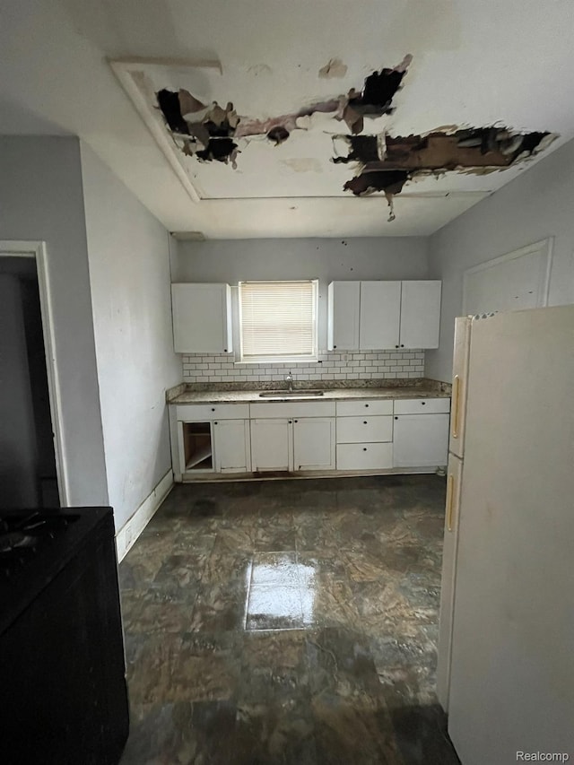 14200 Whitcomb St, Detroit, MI 48227 - kitchen with freestanding refrigerator, backsplash, white cabinets, and light countertops