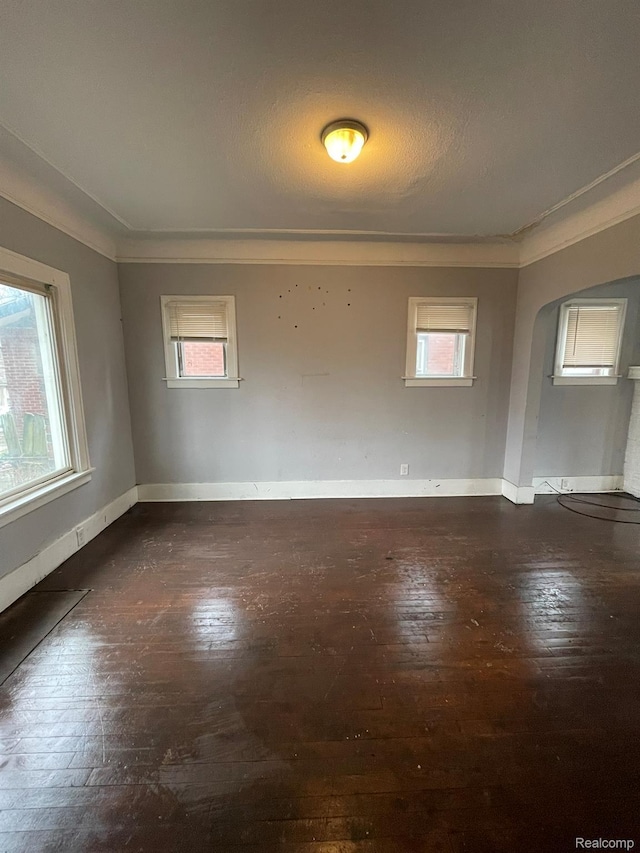 14200 Whitcomb St, Detroit, MI 48227 - unfurnished room featuring wood-type flooring, ornamental molding, plenty of natural light, and arched walkways