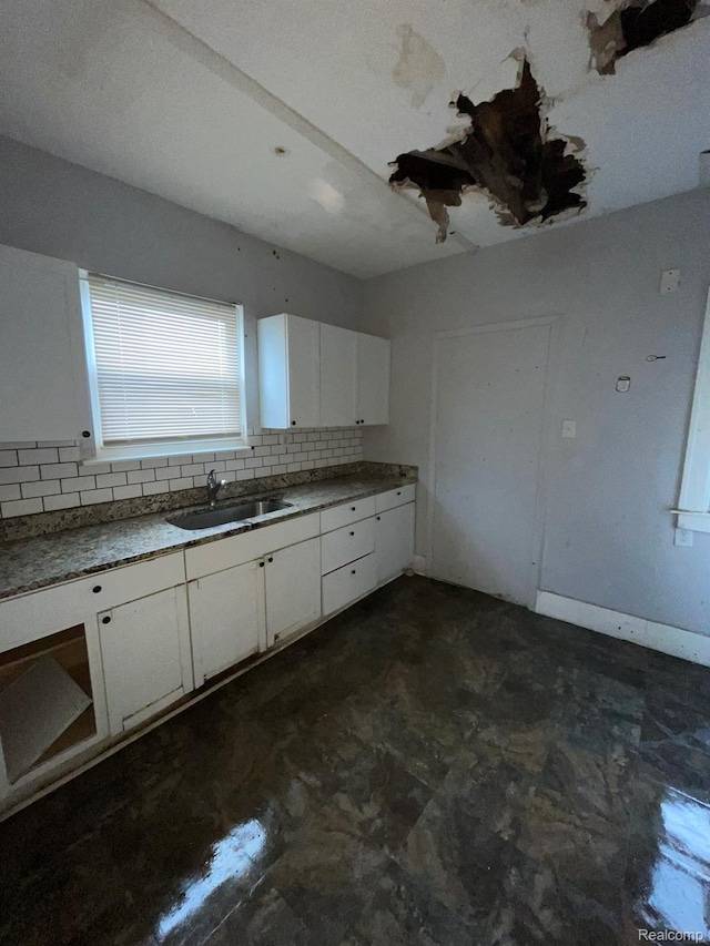 14200 Whitcomb St, Detroit, MI 48227 - kitchen featuring backsplash, white cabinets, and unfinished concrete flooring
