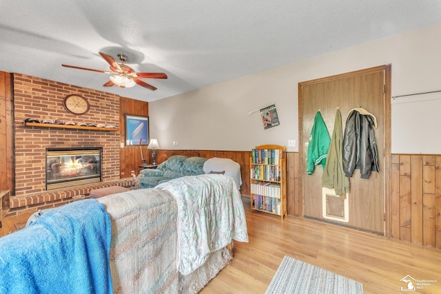 234 Crampton Dr, Monroe, MI 48162 - living area featuring wood walls, ceiling fan, a wainscoted wall, wood finished floors, and a textured ceiling
