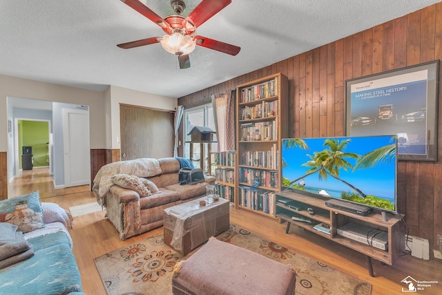 234 Crampton Dr, Monroe, MI 48162 - living area with wooden walls, a ceiling fan, wood finished floors, and a textured ceiling