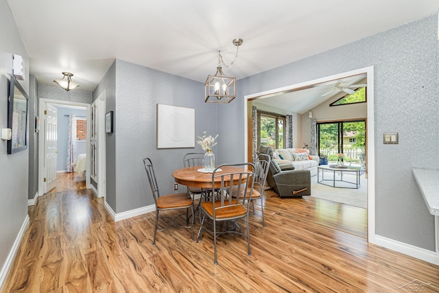 4170 Clement Dr, Saginaw, MI 48603 - dining space featuring light wood-type flooring, lofted ceiling, ceiling fan, and a chandelier