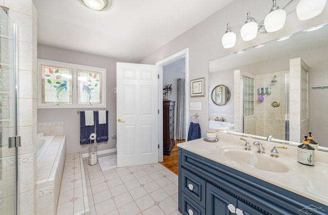 4170 Clement Dr, Saginaw, MI 48603 - bathroom featuring a bath, vanity, a tile shower, and tile patterned flooring