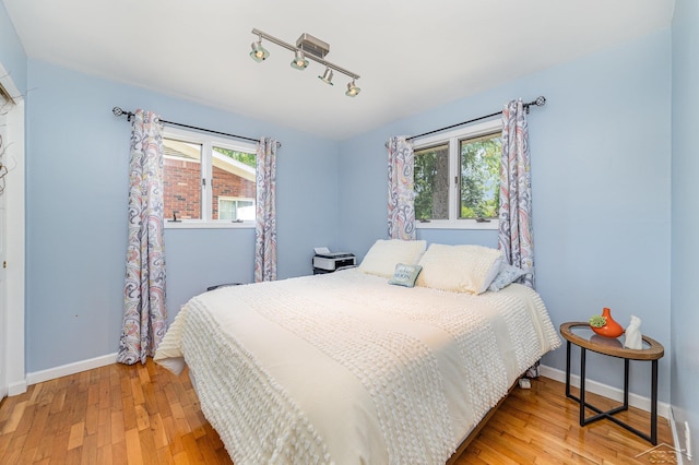 4170 Clement Dr, Saginaw, MI 48603 - bedroom featuring light wood-style floors and rail lighting