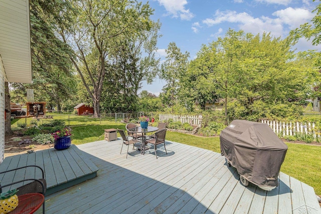 4170 Clement Dr, Saginaw, MI 48603 - deck featuring a fenced backyard, outdoor dining space, grilling area, and view of scattered trees