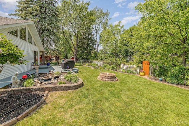 4170 Clement Dr, Saginaw, MI 48603 - fenced backyard with an outdoor fire pit