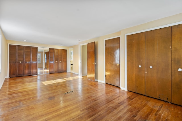 36254 Congress Rd, Farmington Hills, MI 48335 - unfurnished bedroom with multiple closets and light wood finished floors