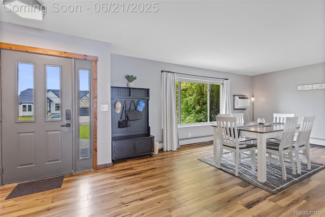 527 Tanview Dr, Oxford, MI 48371 - dining area featuring light wood-style floors, baseboard heating, and a wall mounted air conditioner