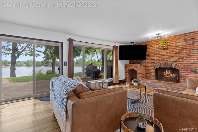 527 Tanview Dr, Oxford, MI 48371 - living room featuring light wood-style flooring, a water view, and a fireplace