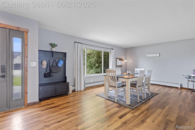 527 Tanview Dr, Oxford, MI 48371 - dining area with baseboard heating, a baseboard heating unit, wood finished floors, and a wall unit AC