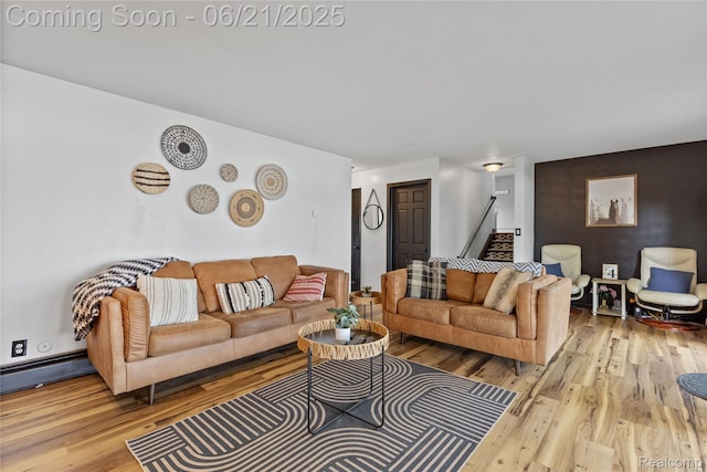 527 Tanview Dr, Oxford, MI 48371 - living room featuring wood finished floors, stairs, and a baseboard heating unit
