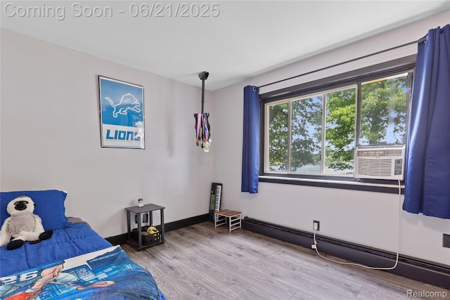 527 Tanview Dr, Oxford, MI 48371 - bedroom featuring wood finished floors and a baseboard radiator