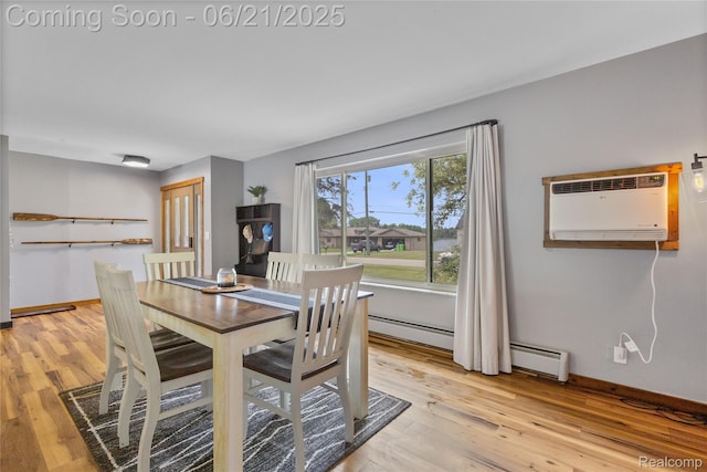 527 Tanview Dr, Oxford, MI 48371 - dining room with a wall unit AC, light wood-type flooring, and a baseboard heating unit