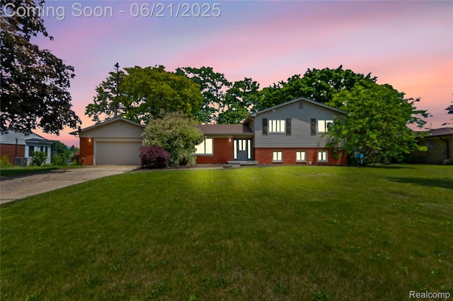 527 Tanview Dr, Oxford, MI 48371 - split level home with a front lawn, concrete driveway, a garage, and brick siding
