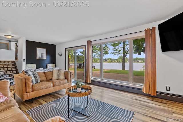 527 Tanview Dr, Oxford, MI 48371 - living room featuring wood finished floors, baseboard heating, and stairs