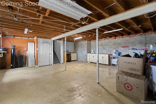 527 Tanview Dr, Oxford, MI 48371 - unfinished below grade area featuring stairs and a water softener