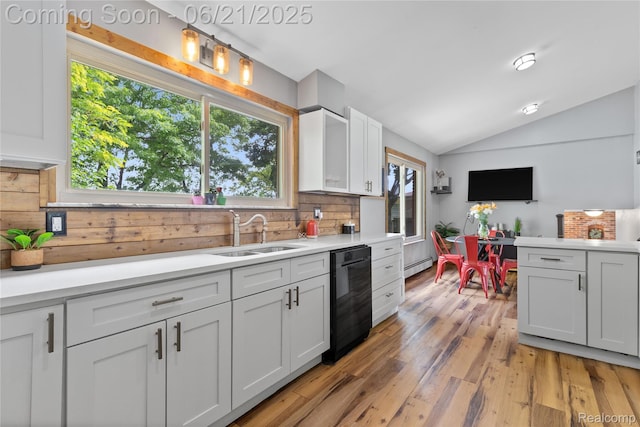 527 Tanview Dr, Oxford, MI 48371 - kitchen with dishwasher, baseboard heating, vaulted ceiling, light countertops, and healthy amount of natural light
