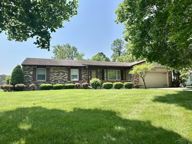 5697 Dunrovin Dr, Saginaw, MI 48638 - single story home with a garage, a front lawn, and brick siding