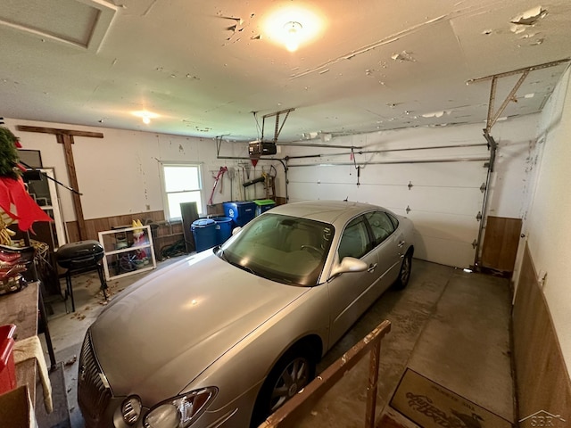 5697 Dunrovin Dr, Saginaw, MI 48638 - garage featuring a garage door opener and wainscoting
