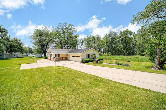 9760 Lime Lake Rd, Hudson, MI 49247 - view of front of house featuring concrete driveway, a front yard, a garage, and a metal roof