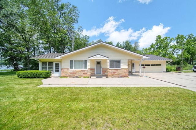 9760 Lime Lake Rd, Hudson, MI 49247 - ranch-style house with a standing seam roof, driveway, a garage, a front yard, and a metal roof