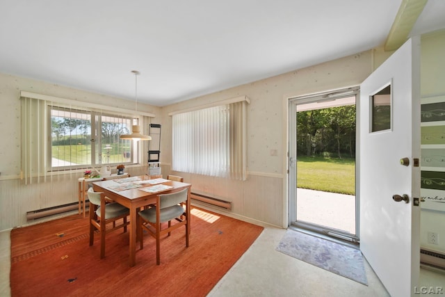 9760 Lime Lake Rd, Hudson, MI 49247 - dining area featuring a baseboard heating unit and a wainscoted wall