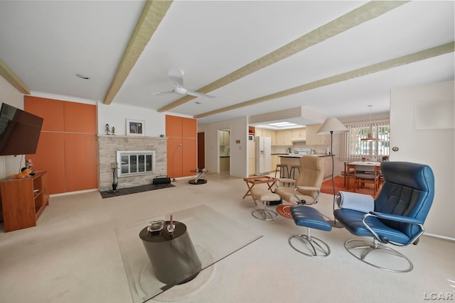 9760 Lime Lake Rd, Hudson, MI 49247 - living area with light carpet, beam ceiling, a fireplace, and ceiling fan