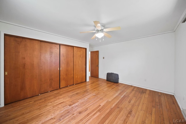 9760 Lime Lake Rd, Hudson, MI 49247 - unfurnished bedroom with light wood-style flooring, a closet, and ceiling fan