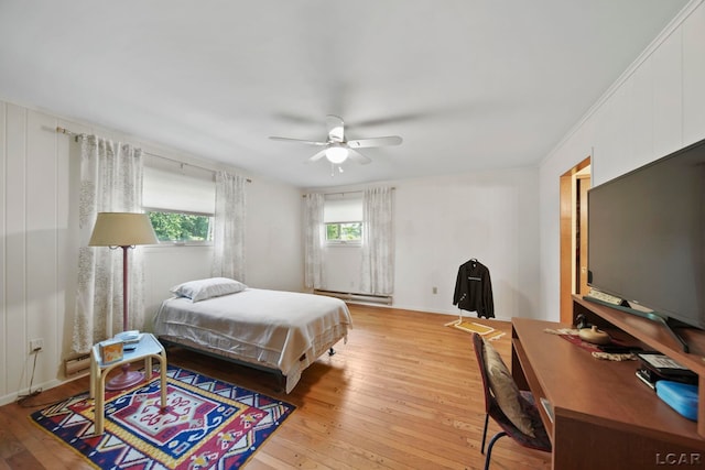 9760 Lime Lake Rd, Hudson, MI 49247 - bedroom with light wood-style flooring, an office area, ceiling fan, and a baseboard heating unit