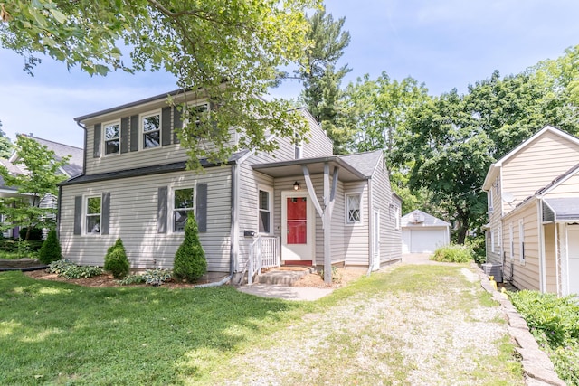 1215 Prescott Ave, Ann Arbor, MI 48103 - view of front of home with a front yard, a garage, and an outbuilding