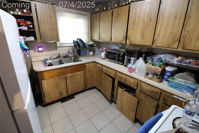 123 Adelaide St, Pontiac, MI 48342 - kitchen featuring light countertops, stainless steel microwave, light tile patterned floors, and brown cabinets
