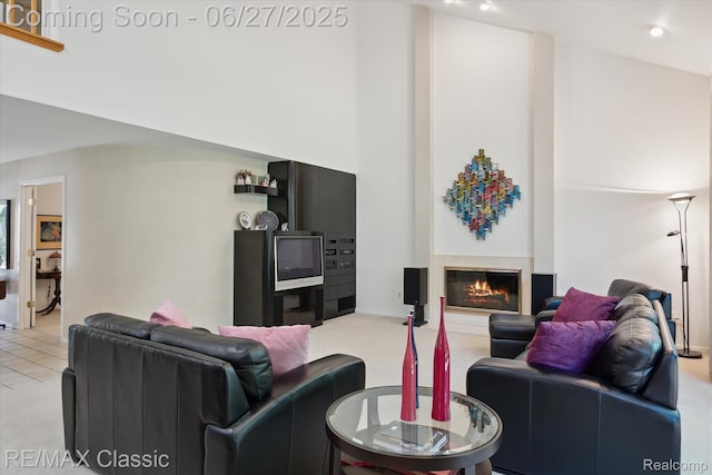 35606 Huntsman Ct, Farmington Hills, MI 48331 - living room with light colored carpet, a glass covered fireplace, and a towering ceiling