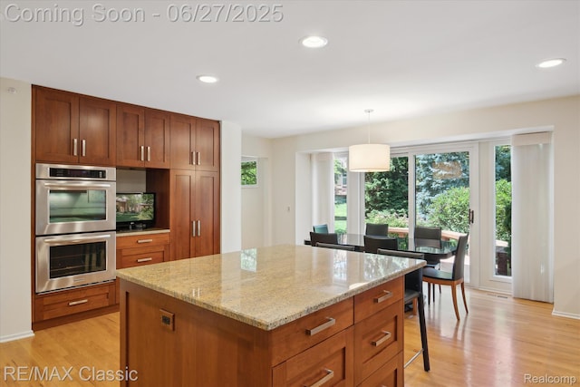35606 Huntsman Ct, Farmington Hills, MI 48331 - kitchen with stainless steel double oven, light wood-style floors, a center island, recessed lighting, and light stone countertops