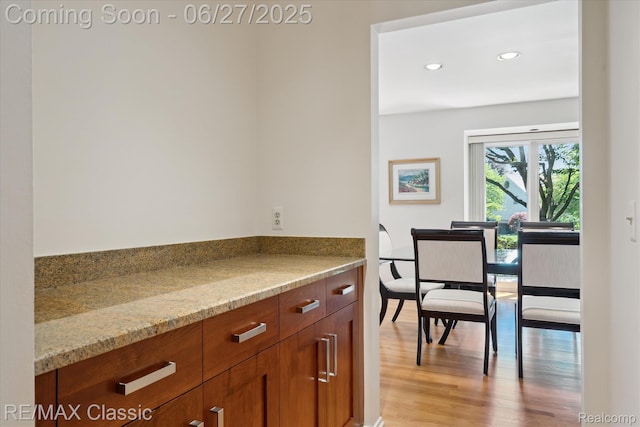 35606 Huntsman Ct, Farmington Hills, MI 48331 - kitchen featuring light wood-type flooring, light stone counters, brown cabinetry, and recessed lighting