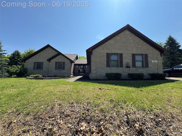 3163 Mystic Valley Dr, White Lake, MI 48383 - view of front facade with brick siding and a front yard