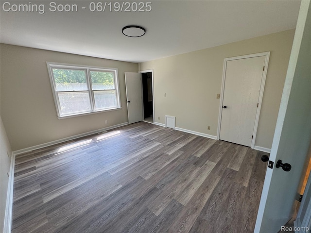 3163 Mystic Valley Dr, White Lake, MI 48383 - unfurnished bedroom with wood finished floors and baseboards