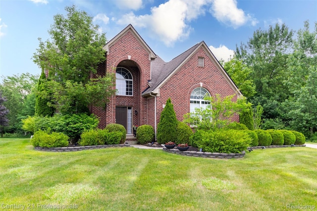 23640 Woodside Ct, South Lyon, MI 48178 - traditional-style home featuring brick siding and a front lawn