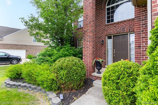 23640 Woodside Ct, South Lyon, MI 48178 - doorway to property with brick siding and a garage