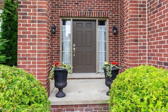 23640 Woodside Ct, South Lyon, MI 48178 - view of exterior entry featuring brick siding