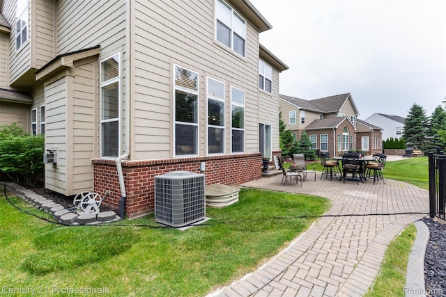 23640 Woodside Ct, South Lyon, MI 48178 - exterior space featuring a patio area, a lawn, and brick siding
