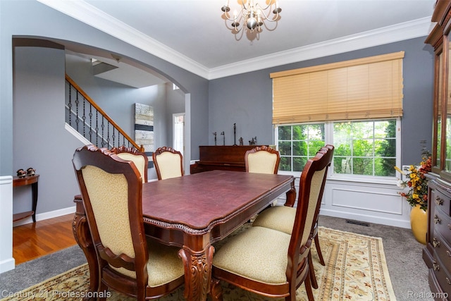 23640 Woodside Ct, South Lyon, MI 48178 - dining room with arched walkways, a chandelier, crown molding, and stairs