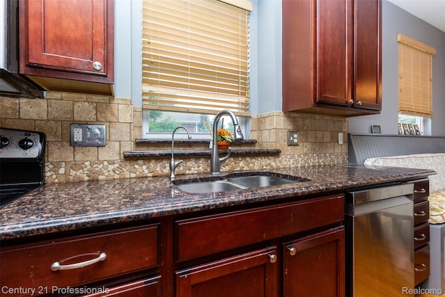 23640 Woodside Ct, South Lyon, MI 48178 - kitchen featuring reddish brown cabinets, stainless steel dishwasher, backsplash, and dark stone countertops