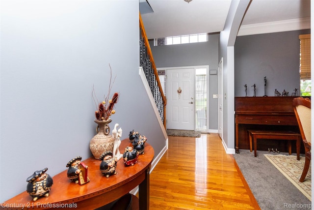23640 Woodside Ct, South Lyon, MI 48178 - foyer entrance featuring ornamental molding, light wood-style flooring, and stairway