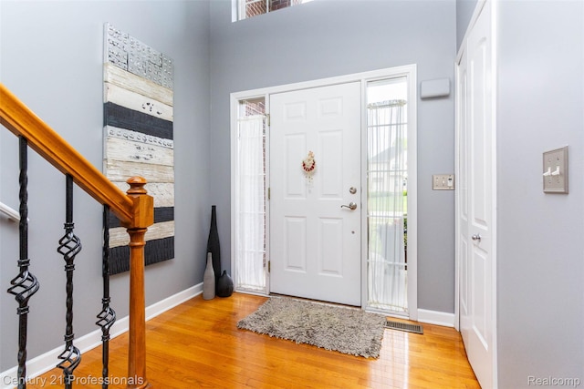 23640 Woodside Ct, South Lyon, MI 48178 - entryway featuring light wood-type flooring and stairs