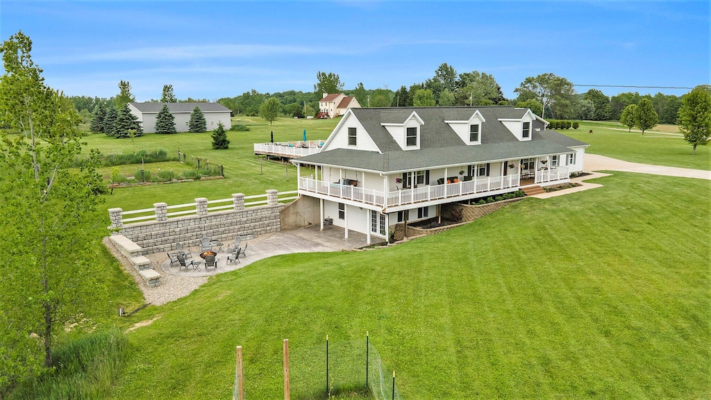 9575 52nd St SE, Alto, MI 49302 - back of house with a patio, a deck, view of wooded area, and roof with shingles