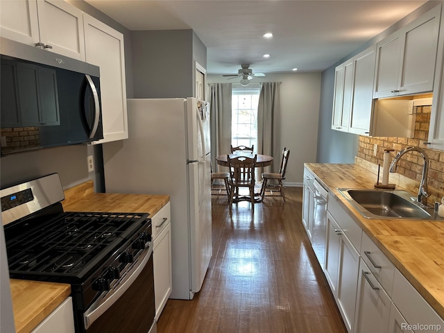 1437 Lantern Ln, Rochester Hills, MI 48306 - kitchen featuring stainless steel appliances, wooden counters, backsplash, ceiling fan, and recessed lighting