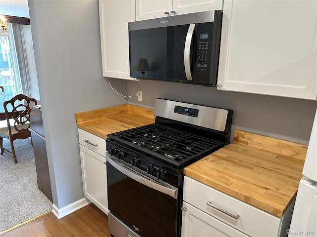 1437 Lantern Ln, Rochester Hills, MI 48306 - kitchen with gas range, butcher block countertops, wood finished floors, and white cabinets