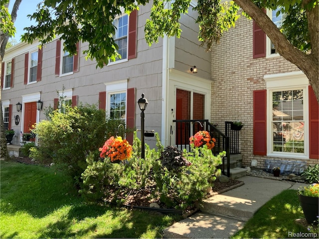 1437 Lantern Ln, Rochester Hills, MI 48306 - doorway to property featuring brick siding and a yard