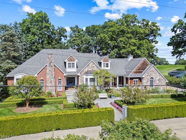 view of front of property featuring stone siding and a chimney