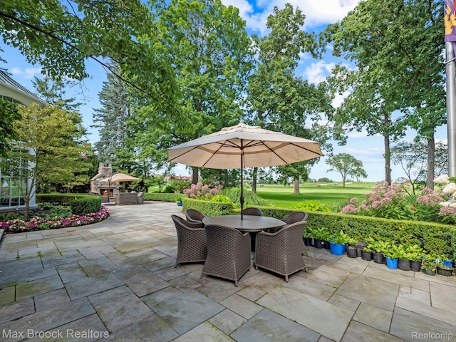 view of patio featuring outdoor dining area and golf course view
